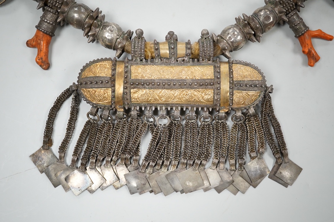 A Bedouin white metal and coral mounted necklace, from Oman, 58cm long
